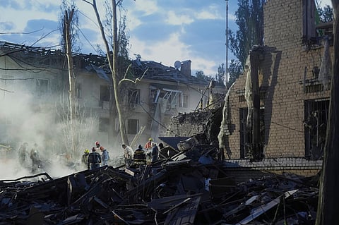 Rescue workers clear the rubble after a Russian ballistic missile attack in Kyiv, Ukraine