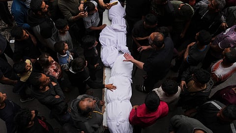 Relatives grieve over the bodies of members of the Jalis and Al-Sharbasi families, killed in an Israeli army airstrike on Yaffa School in Gaza City, Wednesday, April 23, 2025.