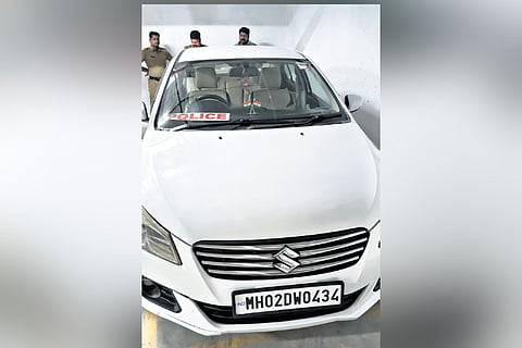 The car bearing a police board and
a CBI sticker on its windshield