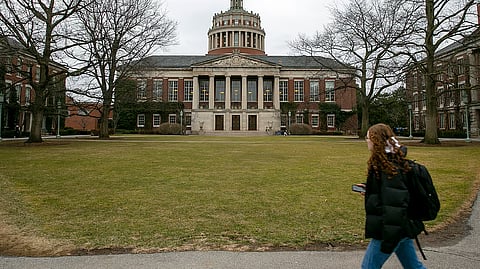 A student walks by the Rush Rhees Library at the University of Rochester, Feb. 22, 2023.