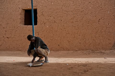 A young migrant who has been expelled from Algeria sits in a transit center in Arlit, Niger on Friday, June 1, 2018.