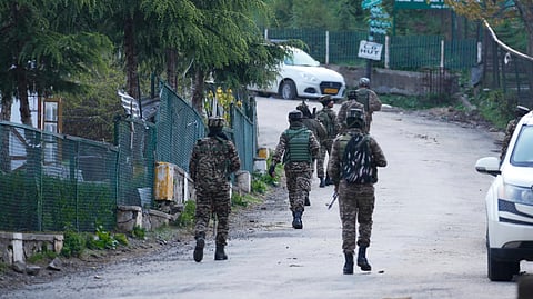 Indian security officers patrol an empty street in Pahalgam a day after militants indiscriminately opened fire on tourists near the town, in Kashmir, Wednesday, April 23, 2025.