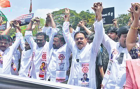 Civil Supplies Minister Nadendla Manohar and JSP activists form a human chain against the Pahalgam terror attack in Vijayawada on Friday.