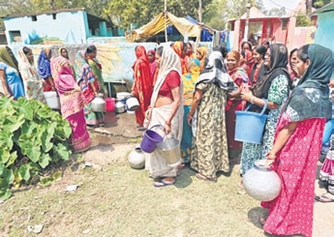 Women of Jhupudipara gather near a public tap to collect water |