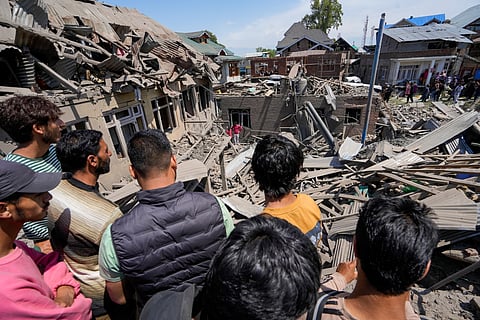 People stand near the house of Ahsan Ul Haq Sheikh, a suspect in the Pahalgam terror attack, which was razed in a blast, in Murran area of Pulwama district, Saturday, April 26, 2025.