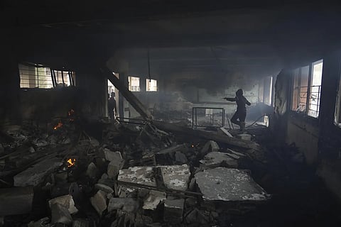 Palestinians inspect the damage after an Israeli airstrike on Yaffa School, in Gaza City, Wednesday, April 23, 2025.