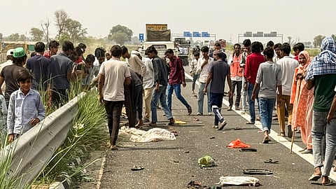 People gather after a road accident that left at least six dead, on the Delhi-Mumbai Expressway in Nuh, Saturday, April 26, 2025.