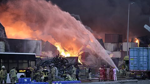 Firefighters try to extinguish the fire, Sunday, April 27, 2025, after a massive explosion and fire rocked a port near the southern port city of Bandar Abbas, Iran, on Saturday.