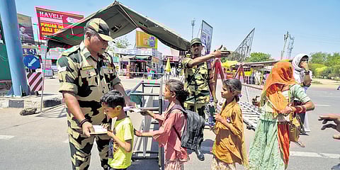 A BSF personnel checks documents of Pakistani nationals arriving to cross over to their country as the deadline to exit India nears its end.