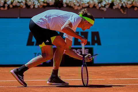 Alexander Zverev of Germany takes a picture with his phone during his Madrid Open round of 32 tennis match against Alejandro Davidovich Fokina of Spain, in Madrid, Spain, Sunday, April 27, 2025.