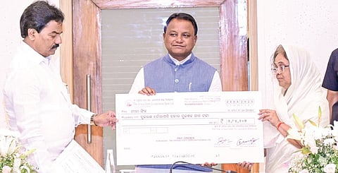 CM Mohan Charan Majhi handing over a cheque to a depositor on Monday.