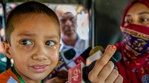 A child with Pakistani nationality cries as his mother, Rukshar, who has an Indian passport, was stopped by authorities from accompanying him to Pakistan, at the Attari-Wagah border checkpost near Amritsar, Monday, April 28, 2025.