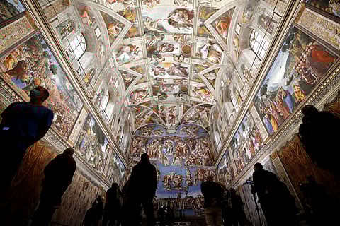 Visitors admire the Sistine Chapel inside the Vatican Museums on the occasion of the museums reopening, in Rome, May 3, 2021
