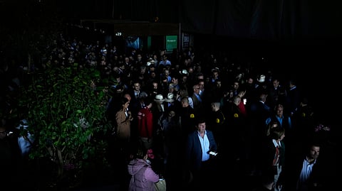 Spectators roam inside the Madrid Open tennis tournament venue during a general blackout in Madrid, Monday, April 28, 2025.