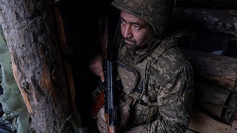 In this photo provided by Ukraine's 93rd Kholodnyi Yar Separate Mechanized Brigade press service, a soldier looks out of a shelter on the anti-drone firing position in Kostyantynivka, the site of the heavy battles with the Russian troops in the Donetsk region, Ukraine, Thursday, April 24, 2025.
