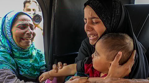 A Pakistani national woman gets emotional while leaving for Pakistan as her son with Indian nationality was stopped by the authorities to go with her, at the Attari-Wagah border checkpost near Amritsar, Tuesday, April 29, 2025.