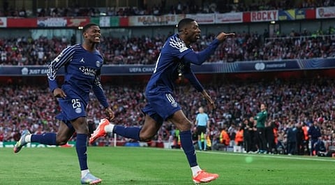 PSG's French forward #10 Ousmane Dembele (R) celebrates after scoring his team first goal against Arsenal during the UEFA Champions League Semi-final First Leg football match on April 29, 2025.