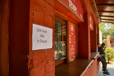 A notice at the ticket counter reads, "Dilli Haat INA is closed," a day after a fire gutted over 30 shops, in New Delhi, Thursday, May 1, 2025. The Delhi Police said it has launched an investigation into the fire at the popular market in south Delhi's INA area.