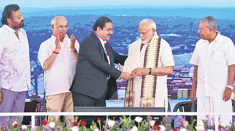 Adani Group chairman Gautam Adani presents a shawl to Prime Minister Narendra Modi during the dedication ceremony of Vizhinjam International Seaport on Friday. Minister V N Vasavan, Union minister Suresh Gopi, Governor Rajendra Arlekar, Chief Minister Pinarayi Vijayan and Union minister George Kurian are also seen.