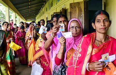 People wait to cast their votes during Panchayat elections at Baraigram in Karimganj, Friday, May 2, 2025.
