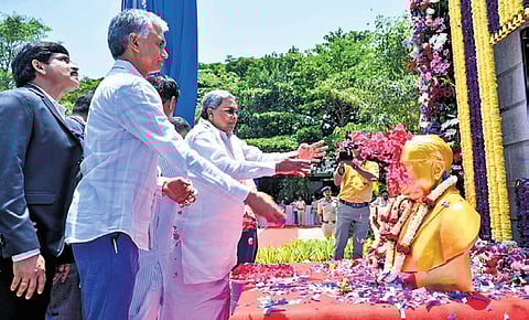 Chief Minister Siddaramaiah offers floral tributes to the statue of Dr BR Ambedkar in Yelahanka on Saturday.