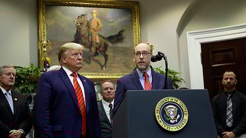 US President Donald Trump listens as acting director of the Office of Management and Budget Russ Vought speaks during an event in the Roosevelt Room of the White House.