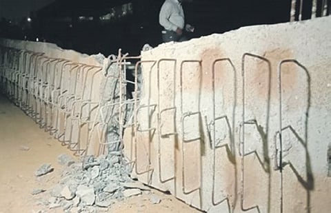 The collapsed concrete slab lies at the construction site