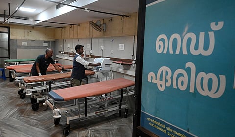 Staff and volunteers arranging the Temporary casualty wing at the old Emergency Department at Kozhikode Medical College Hospital