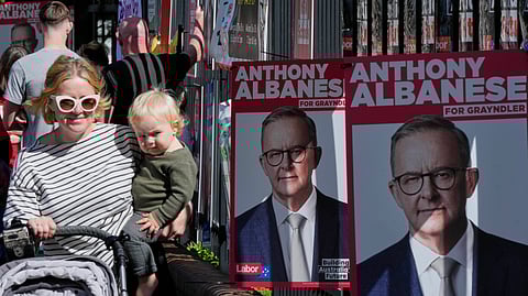 People arrive to vote at a polling booth in Prime Minister Anthony Albanese's electorate in Sydney, Saturday, May 3, 2025.