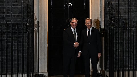 Britain's Prime Minister Keir Starmer (L) welcomes Canada's Prime Minister Mark Carney (R) outside 10 Downing Street in central London on March 17, 2025.