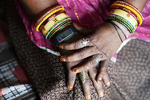 A wristwatch-style health monitor to study how heat affects vulnerable communities is worn by Shantaben Vanzara at her house in Ahmedabad, India, Wednesday, April 2, 2025.