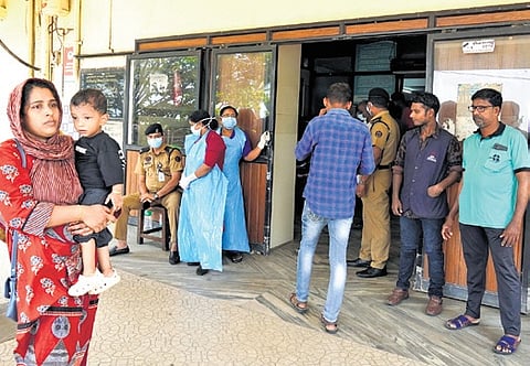 People outside the casualty wing of the Kozhikode Medical College Hospital