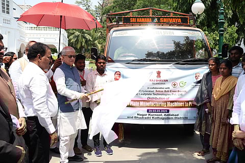Governor Jishnu Dev Varma flags off vehicles carrying machinery for the production of ecofriendly leaf plates and cups to tribal villages at Raj Bhavan, Hyderabad, on Saturday