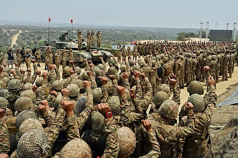 In this photo released by the Inter Services Public Relations, Pakistan's Army Chief Asim Munir, second left standing on tank, chant 'long live Pakistan' slogans with soldiers during his visit to witness military exercises, in Tilla Field Firing Range in the Jhelum district, Pakistan, Thursday, May 1, 2025.