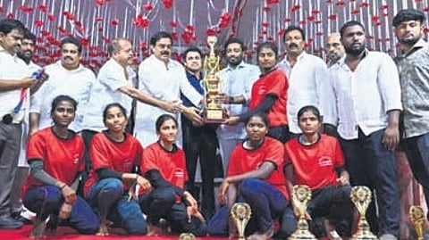 The winning team poses with the trophy.