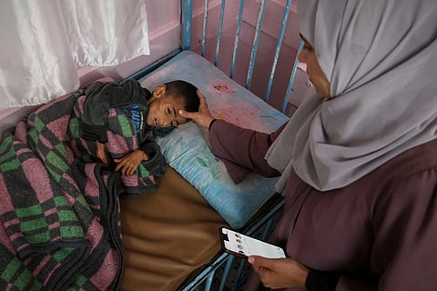 Mona al-Raqab cares for her son Osama, 5, which she says his cystic fibrosis has worsened since the start of the war due to the lack of meat, fish and enzyme tablets to help him digest food, at a malnutrition clinic in Nasser hospital, Khan Younis, Gaza Strip, Thursday, May 1, 2025.