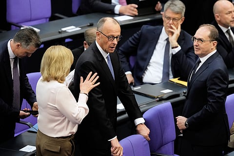 Friedrich Merz reacts after he was not elected new Chancellor in the first voting process at the parliament Bundestag in Berlin (Photo | AP)