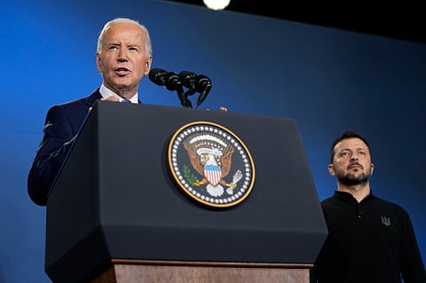 Joe Biden, left, joined by President of Ukraine Volodymyr Zelenskyy, speaks during an event on the Ukraine Compact on the sidelines of the NATO Summit in Washington, Thursday, July 11, 2024.