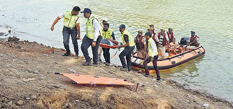 Rescue personnel use a raft, as they carry out a civil defence mock drill on Ulsoor Lake, near the Civil Defence Headquarters in Bengaluru on Wednesday