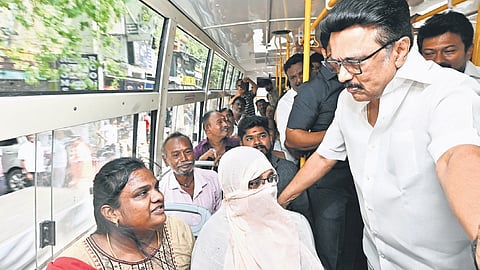 The CM speaking to female passengers on a Vidiyal Payanam bus.