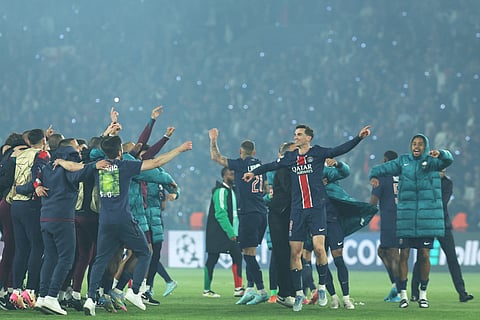Paris Saint-Germain's players celebrate their victory at the end of the UEFA Champions League semi-final second leg football match between Paris Saint-Germain (PSG) and Arsenal at the Parc des Princes stadium in Paris, on May 7, 2025.