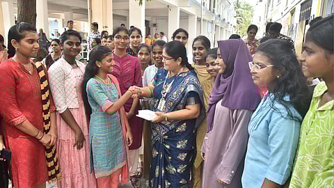 Students and staff celebrate the release of Class XII examination results at a private school in Chennai on Thursday.