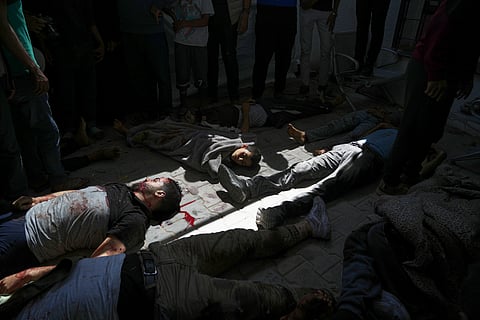 Bodies of some of the victims of an Israeli army strike on a restaurant, which killed at least 29 people, lie on the floor after the were taken from the scene to the Shifa hospital in Gaza City, Wednesday, May 7, 2025.