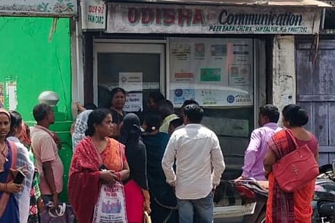 Beneficiaries outside a common services centre in Sambalpur