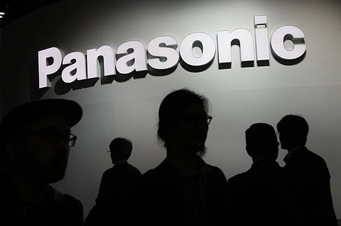 People walk by the Panasonic booth during CES International in Las Vegas on Jan. 9, 2018.
