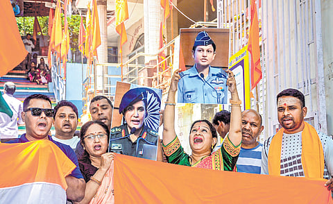 People carrying the photos of Colonel Sofiya Qureshi and Wing Commander Vyomika Singh after the puja performed for the safety of Indian soldiers in Ranchi, Jharkhand, on Friday.