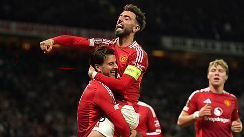 Manchester United's Mason Mount, left, celebrates with Bruno Fernandes after scoring their first goal of the game during the Europa League semifinal second leg soccer match between Manchester United and Athletic Bilbao on May 8, 2025.