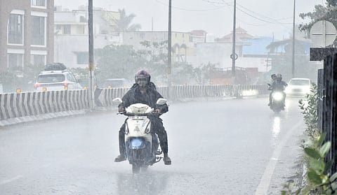 Motorists passing Valankulam lake as heavy rain lashes Coimbatore city.