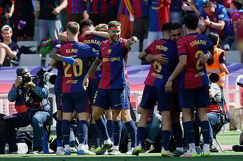 Barcelona players celebrate after a goal during the La Liga soccer match between Barcelona and Real Madrid in Barcelona, Spain, Sunday, May 11, 2025.