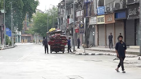 Vendors and other people seen on the street even as shops remain closed, a day after India and Pakistan agreed to a ceasefire along the Line of Control and International Border, at Lal Chowk in Srinagar, Sunday, May 11, 2025.